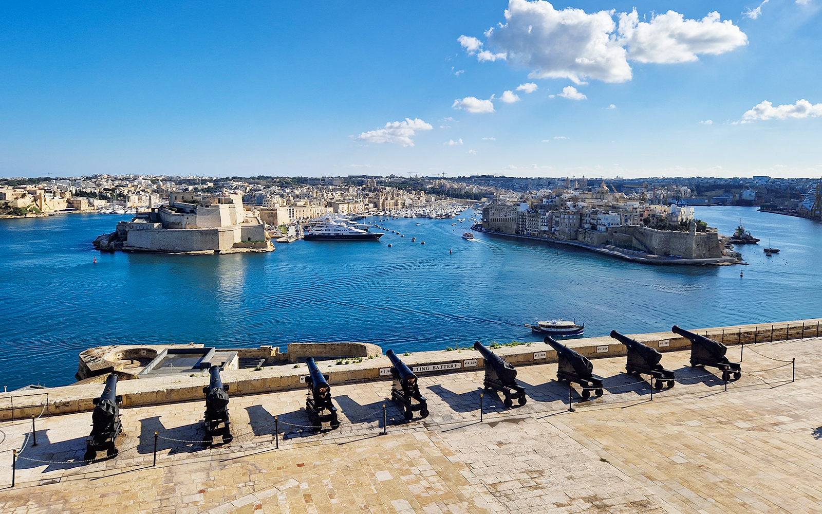 Harbor view with historic fortifications and cannons in Valletta, Malta, part of 3 Cities Tour.