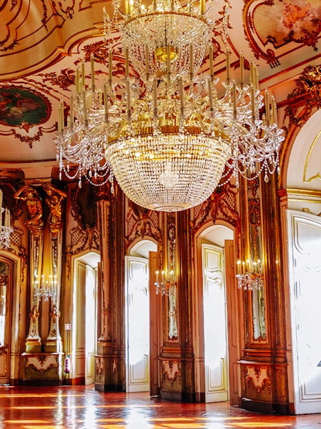 National Palace of Queluz Throne Room with ornate chandeliers and gilded decor.