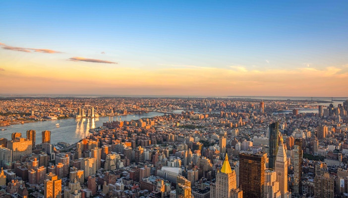 Empire State Building view from observation deck overlooking New York City skyline.