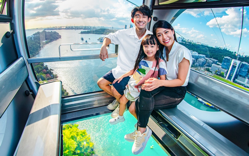 Family enjoying the view from the Sky Orb ride over a scenic waterfront.