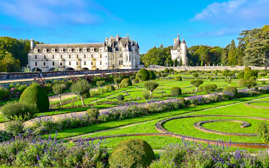 Chenonceau Castle with manicured gardens in Loire Valley, France.