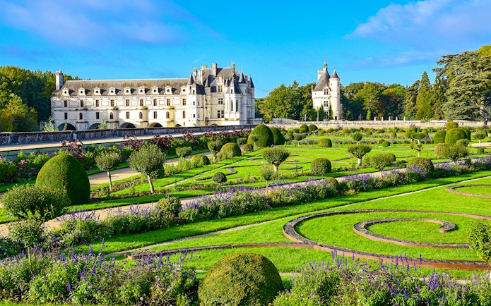Chenonceau Castle with manicured gardens in Loire Valley, France.