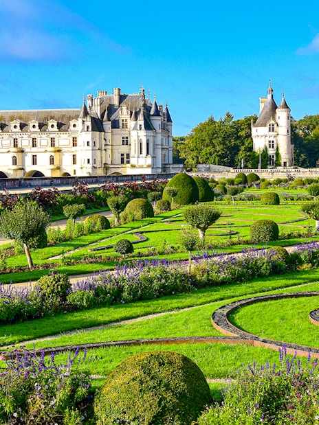 Chenonceau Castle with manicured gardens in Loire Valley, France.