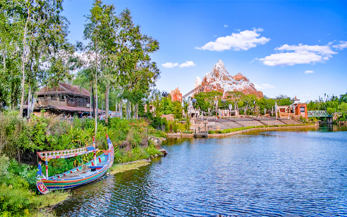 Expedition Everest mountain and colorful boat on the water in Frontierland, Walt Disney World, Orlando.
