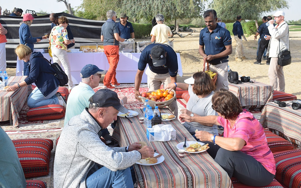 Guests enjoying breakfast during a Sunrise Morning Desert Safari.