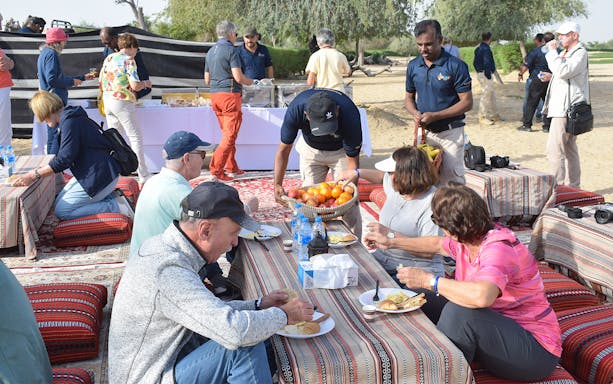 Guests enjoying breakfast during a Sunrise Morning Desert Safari.