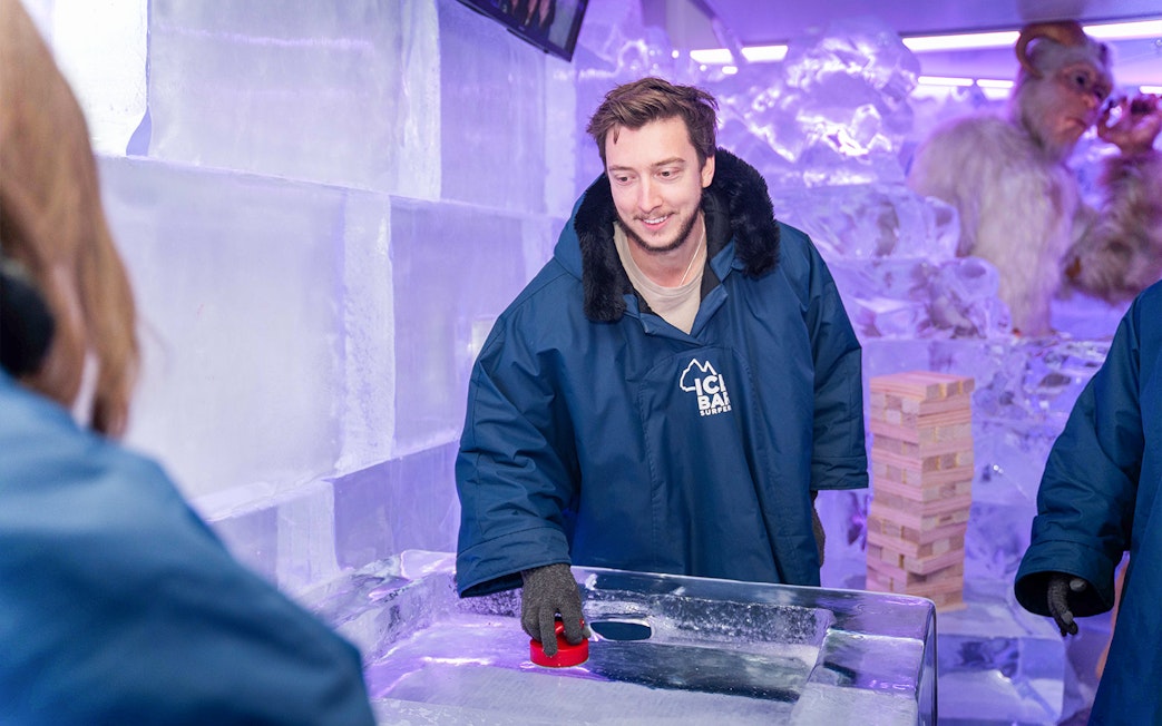 Man playing ice shuffleboard at IceBar Surfers Paradise.