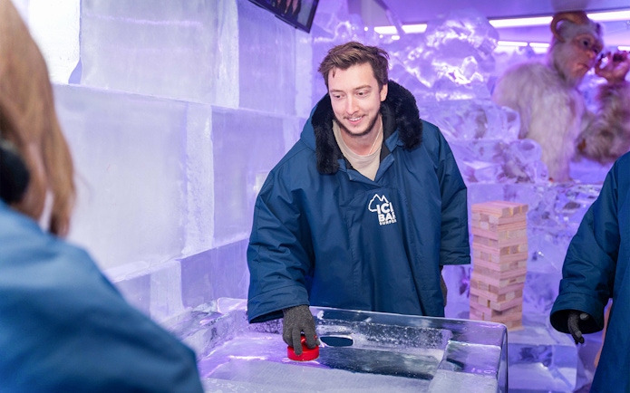 Man playing ice shuffleboard at IceBar Surfers Paradise.