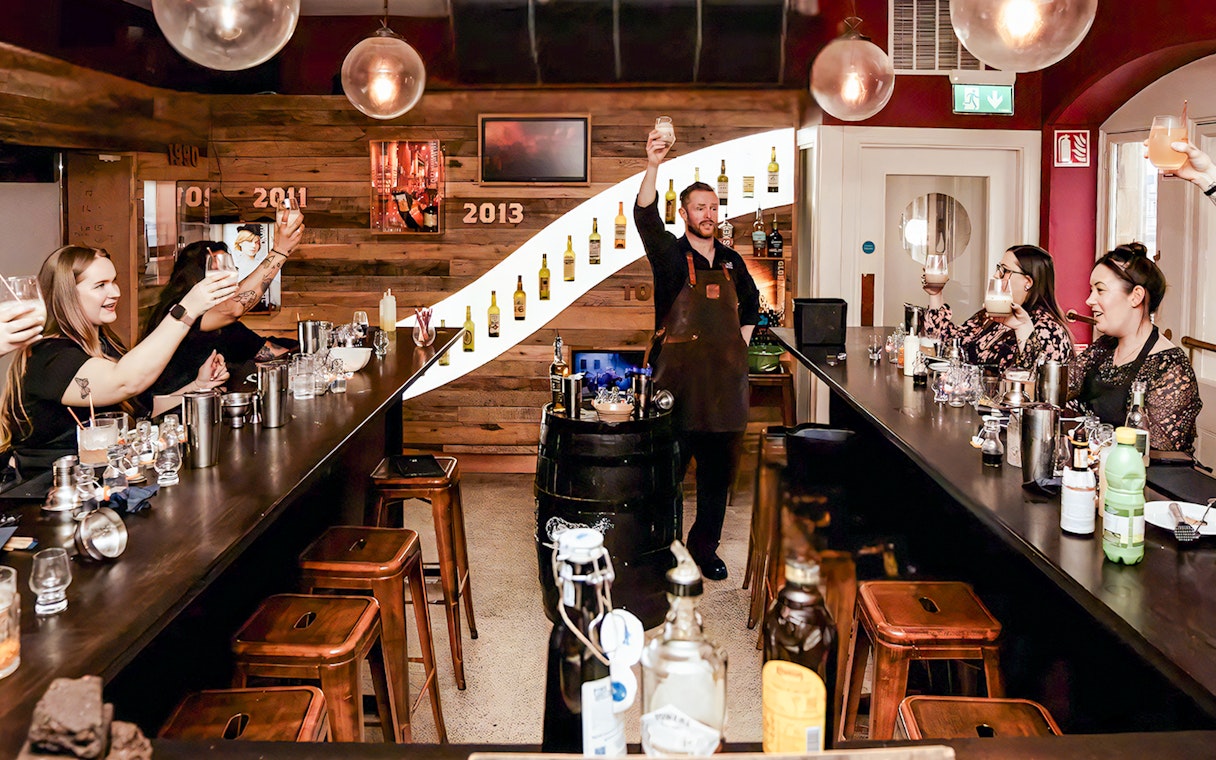 Guests raising glasses at cocktail masterclass in the Irish Whiskey Museum.