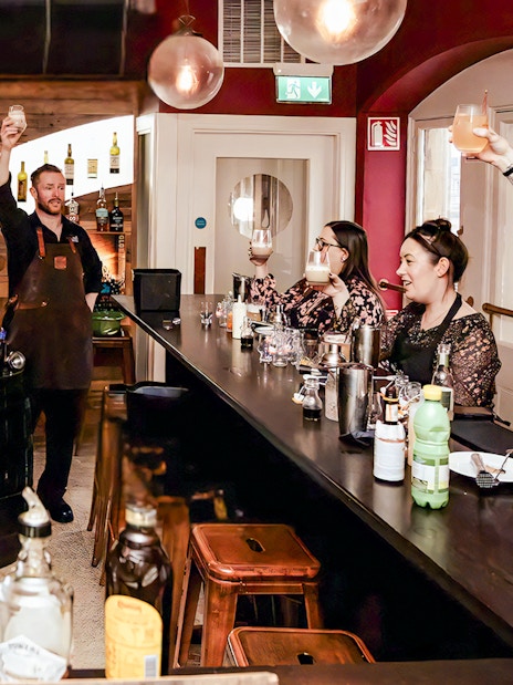 Guests raising glasses at cocktail masterclass in the Irish Whiskey Museum.