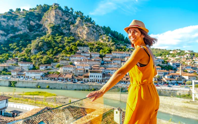 Young woman overlooking the historic cityscape of Berat, Albania.