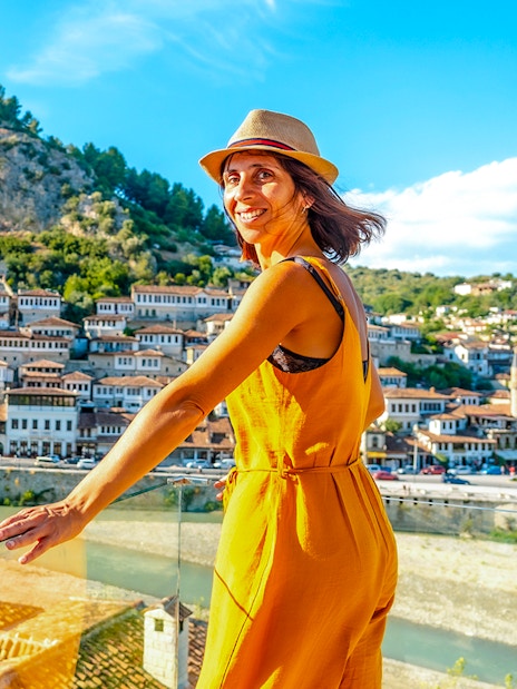 Young woman overlooking the historic cityscape of Berat, Albania.