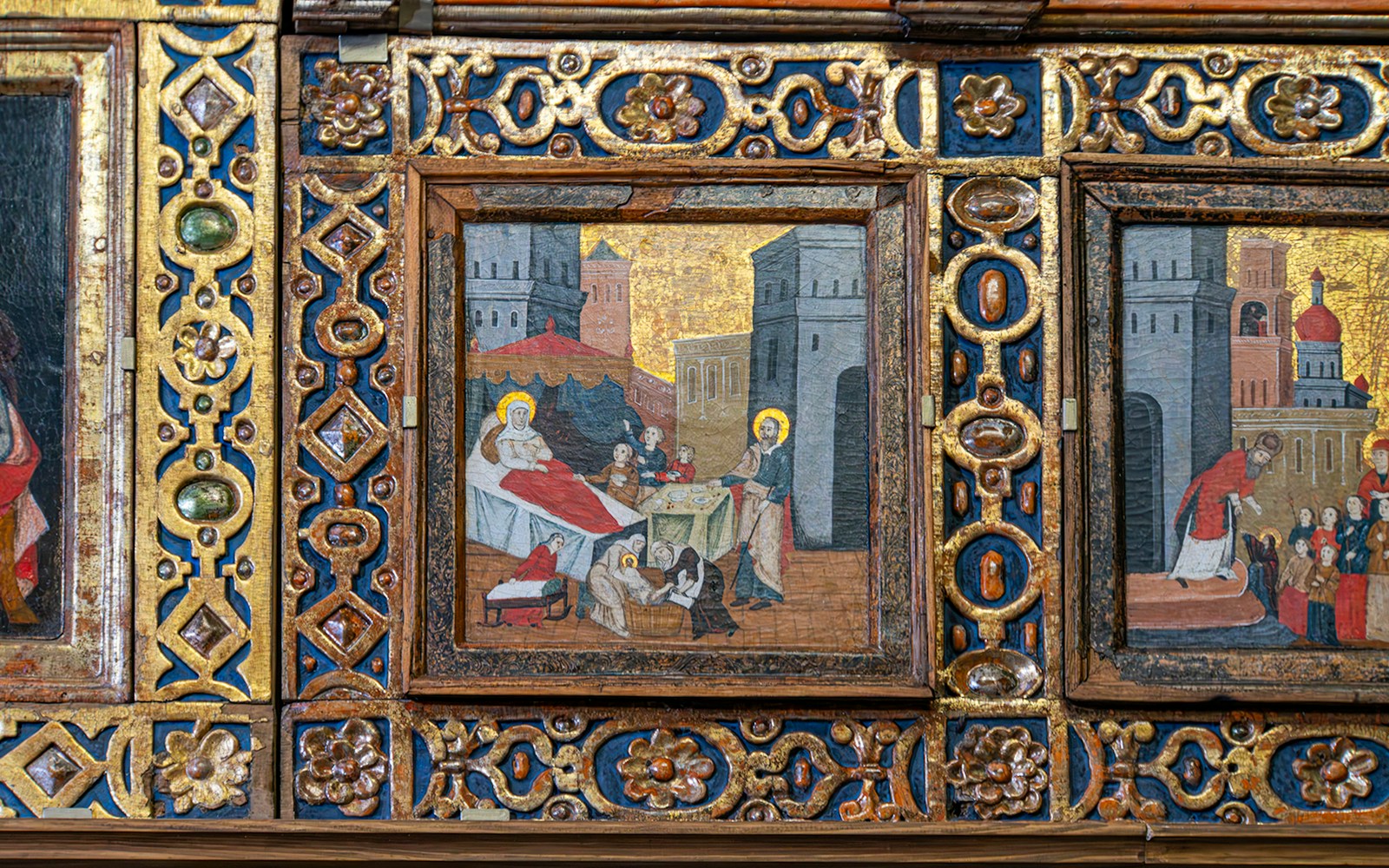 Iconostasis panel depicting religious scene in an Orthodox church with ornate gold detailing.