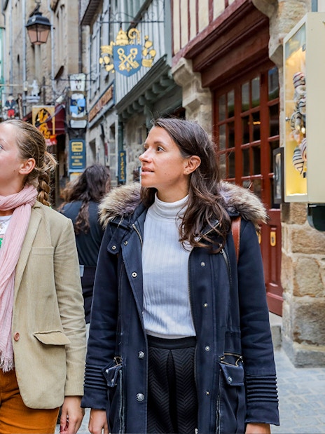 Visitors exploring the narrow streets of Mont Saint-Michel on a guided tour.