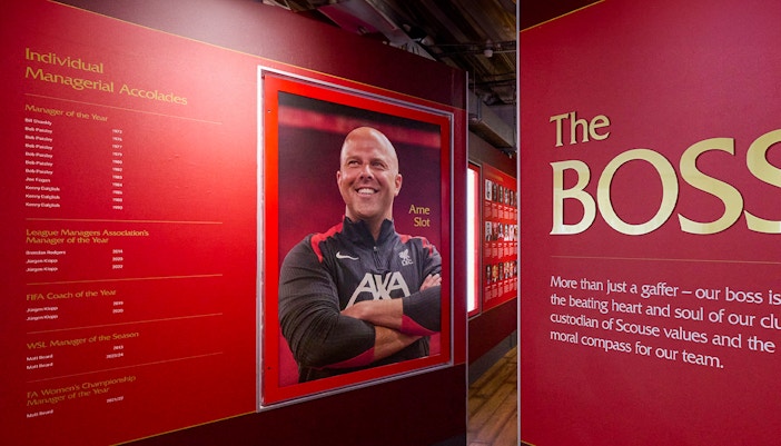 Liverpool FC Stadium tour exhibit featuring managerial accolades and a portrait of a coach.