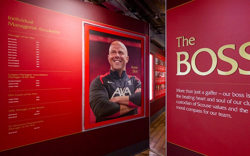 Liverpool FC Stadium tour exhibit featuring managerial accolades and a portrait of a coach.