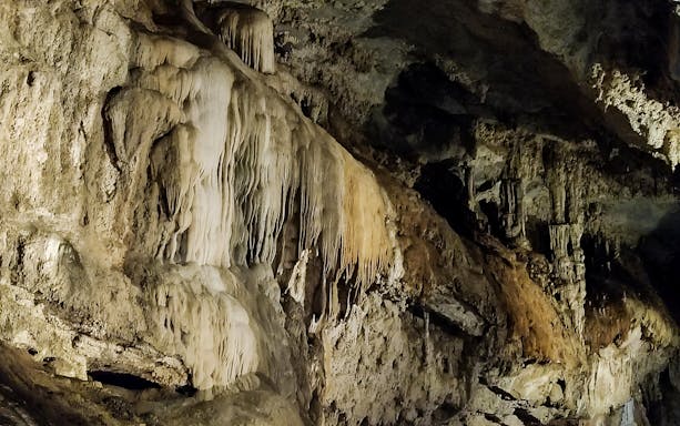 Stalactites and rock formations inside San Giovanni Caves on the Vagoni Path trek.