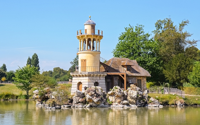 Queen's Hamlet tower and cottage by the lake in Versailles, France.