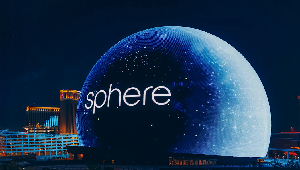 Exterior view of the illuminated Sphere in Las Vegas at night.