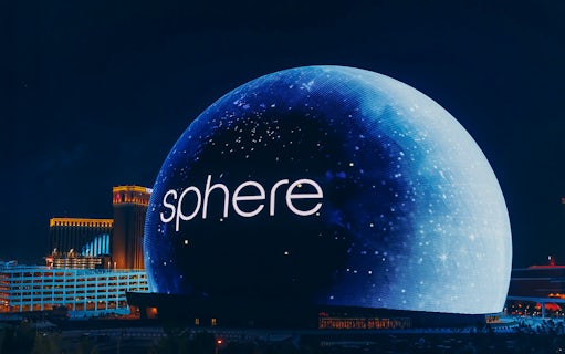 Exterior view of the illuminated Sphere in Las Vegas at night.