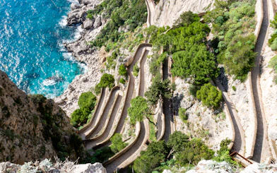 Via Krupp switchback path on Capri, Italy, with coastal cliffs and turquoise sea.