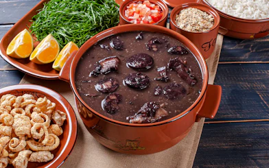 Feijoada with oranges, greens, rice, and farofa in Rio de Janeiro.