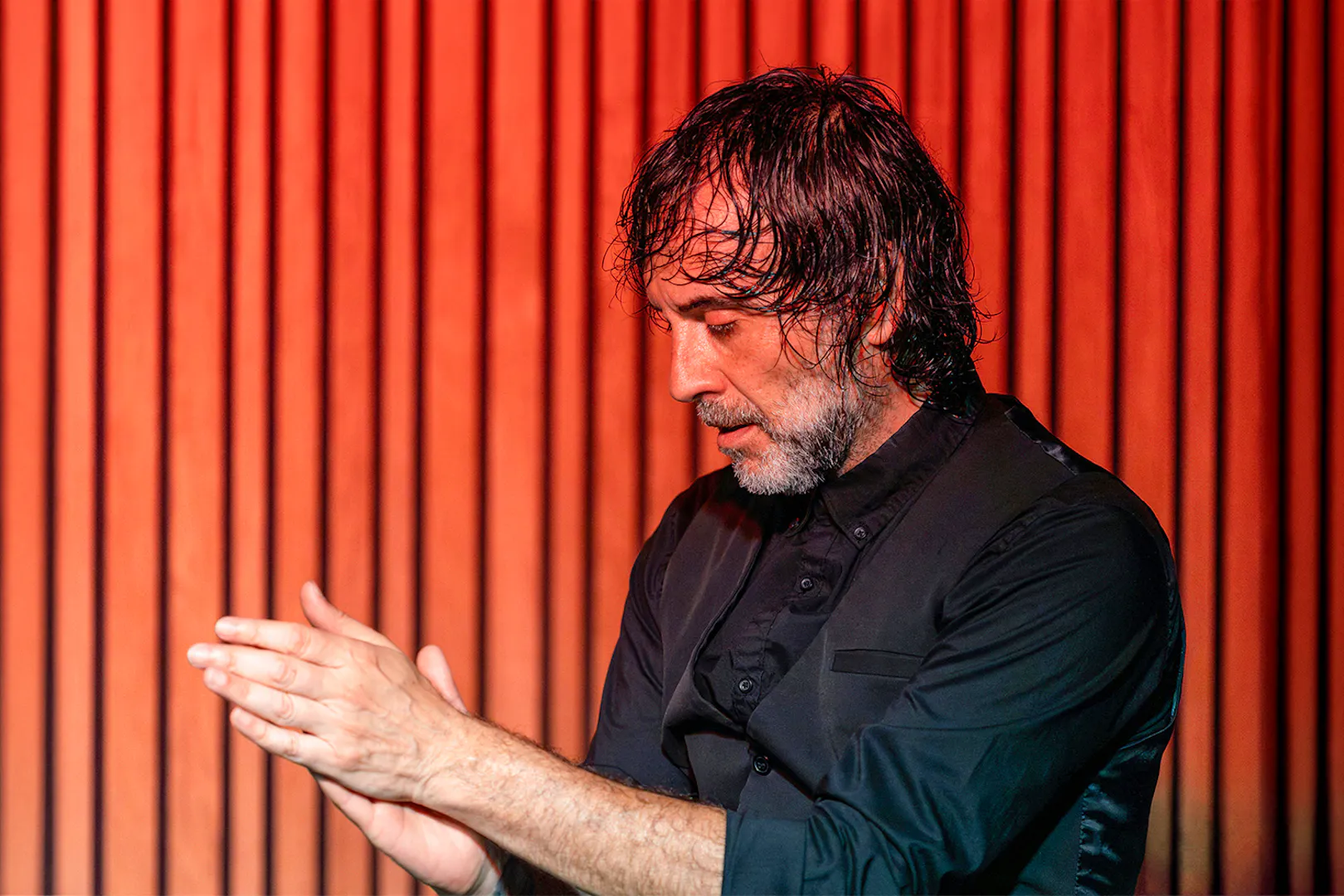 Performer clapping during a flamenco show at La Perla del Born, Barcelona.