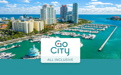 Drone view of Miami Beach marina with yachts and high-rise buildings.