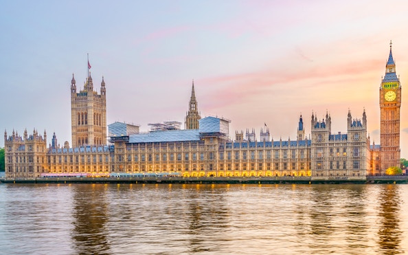 Houses of Parliament viewed from the Thames River at sunset.