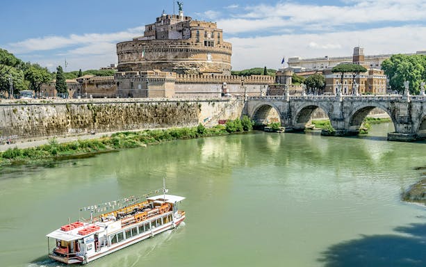 Cruise boat on the Tiber River near Castel Sant'Angelo, Rome.
