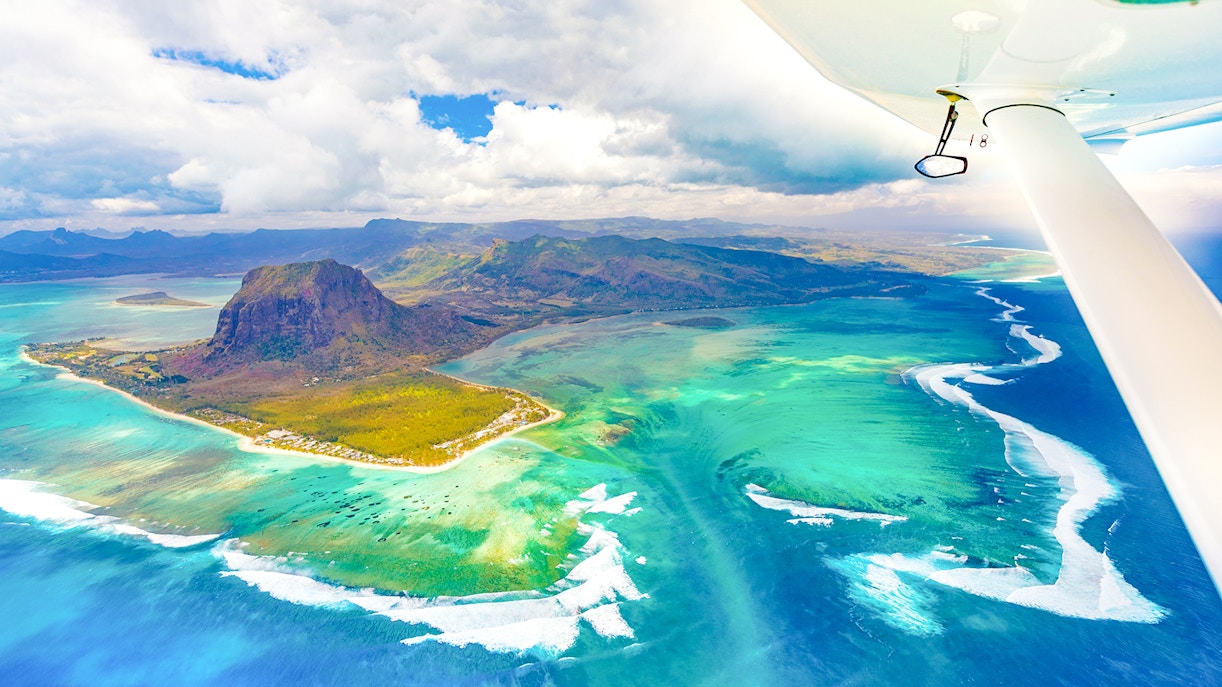 Aerial view of Le Morne Brabant and turquoise waters during a seaplane tour, Mauritius.