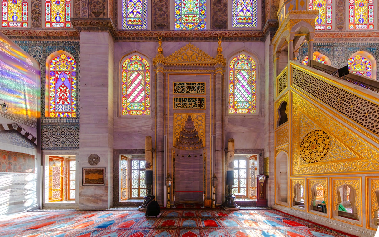 Stained glass windows and ornate mihrab inside the Blue Mosque, Istanbul.