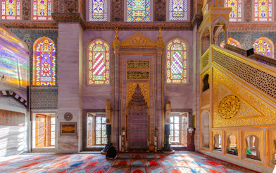 Stained glass windows and ornate mihrab inside the Blue Mosque, Istanbul.