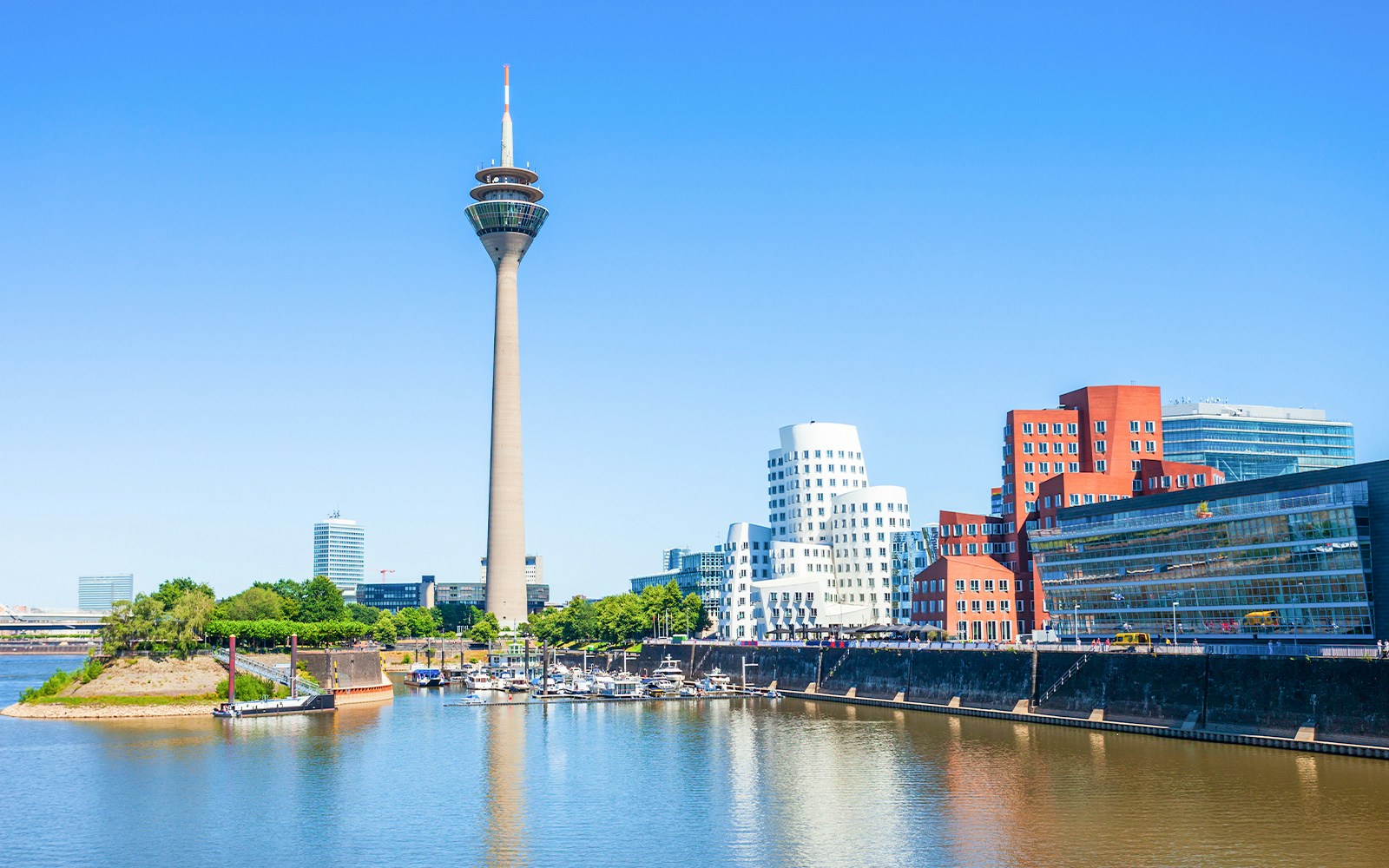 Rheinturm tower and modern buildings along the River Rhine in Dusseldorf.