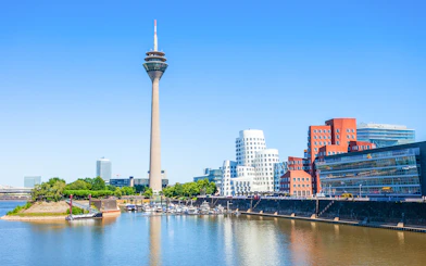 Rheinturm tower and modern buildings along the River Rhine in Dusseldorf.