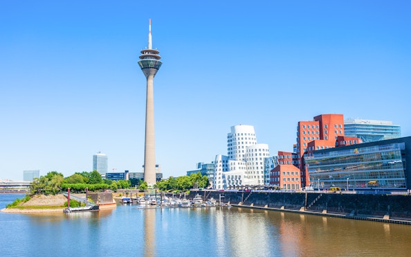 Rheinturm tower and modern buildings along the River Rhine in Dusseldorf.