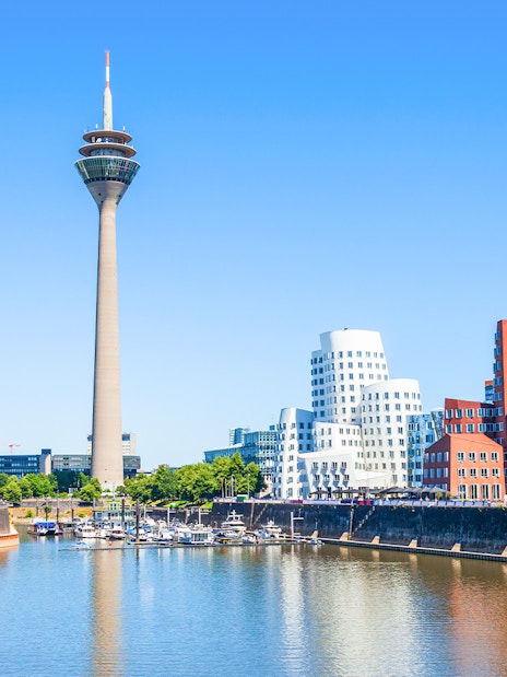 Rheinturm tower and modern buildings along the River Rhine in Dusseldorf.