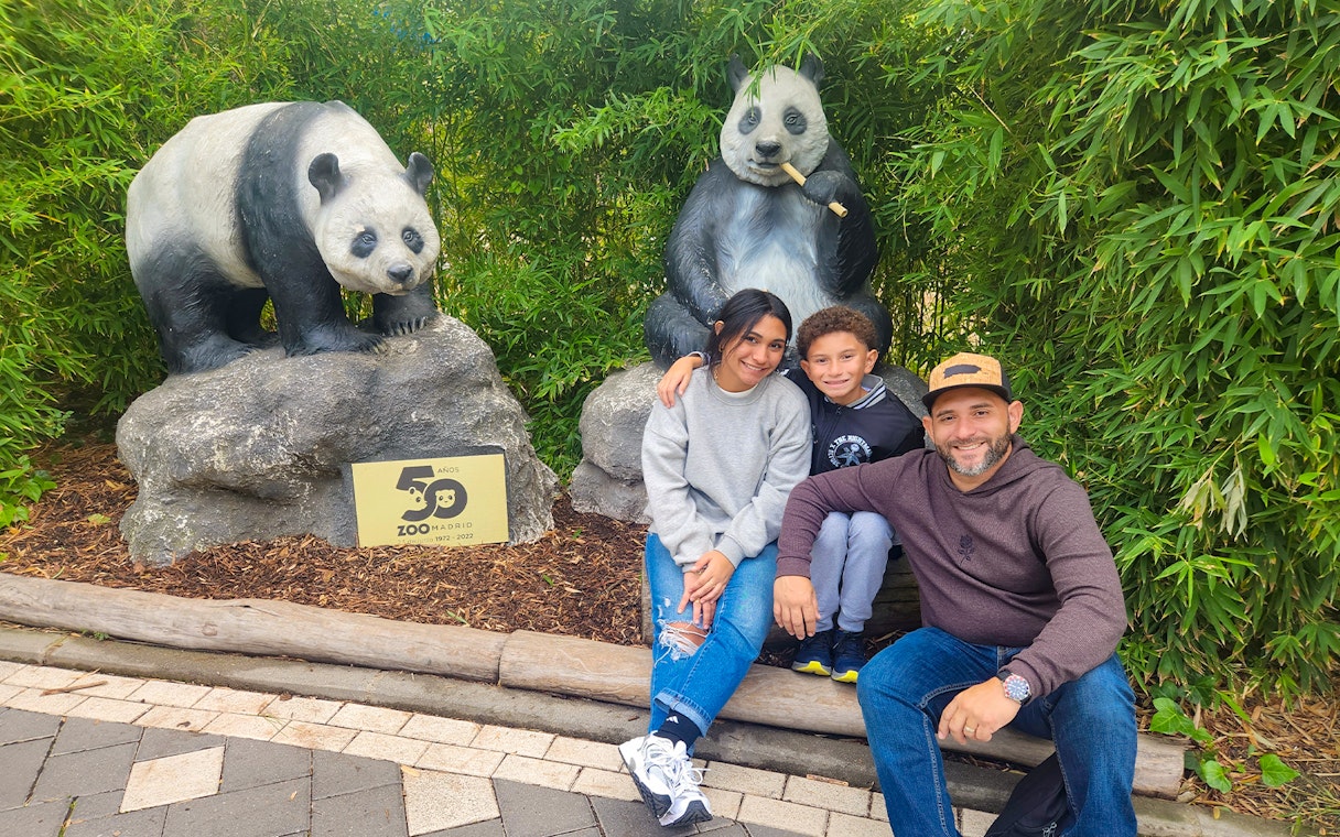 Family posing with panda statues at Zoo Aquarium Madrid.