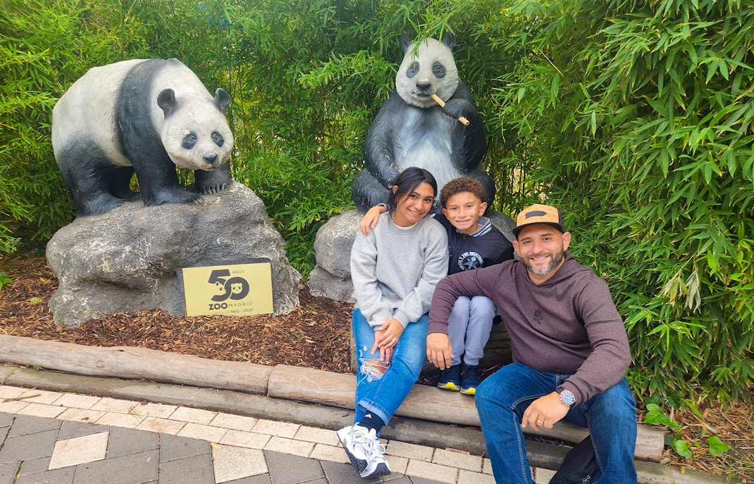Family at Zoo Aquarium Madrid with panda statues