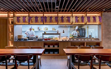 Chefs preparing dishes at Plaza Premium First lounge, Satellite Terminal.