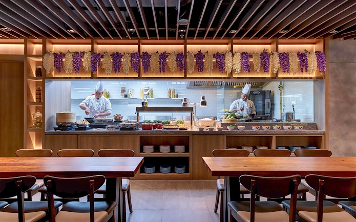 Chefs preparing dishes at Plaza Premium First lounge, Satellite Terminal.