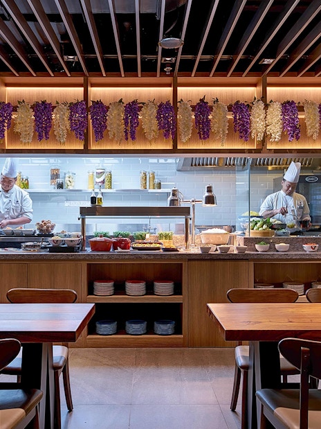 Chefs preparing dishes at Plaza Premium First lounge, Satellite Terminal.