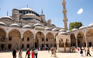 Courtyard of Hagia Sophia with visitors exploring the historic architecture in Istanbul.