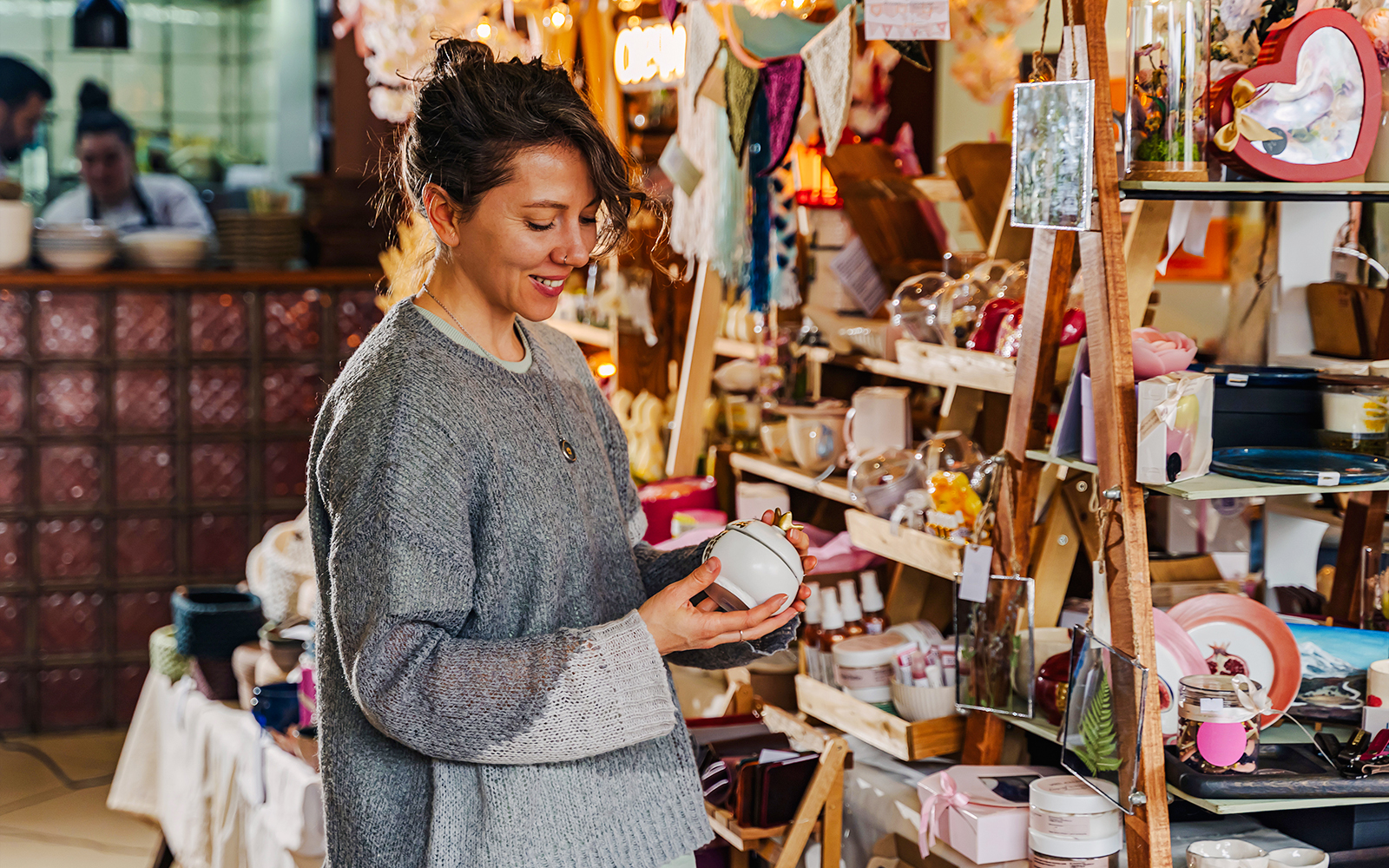 Woman browsing handmade jewelry in a Tenerife market shop.