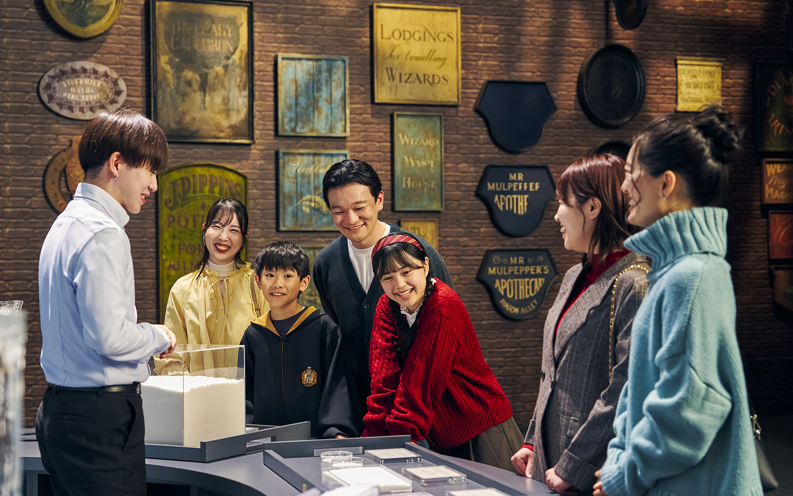 Family enjoying interactive exhibit at The Making of Harry Potter Studio Tour, Tokyo.