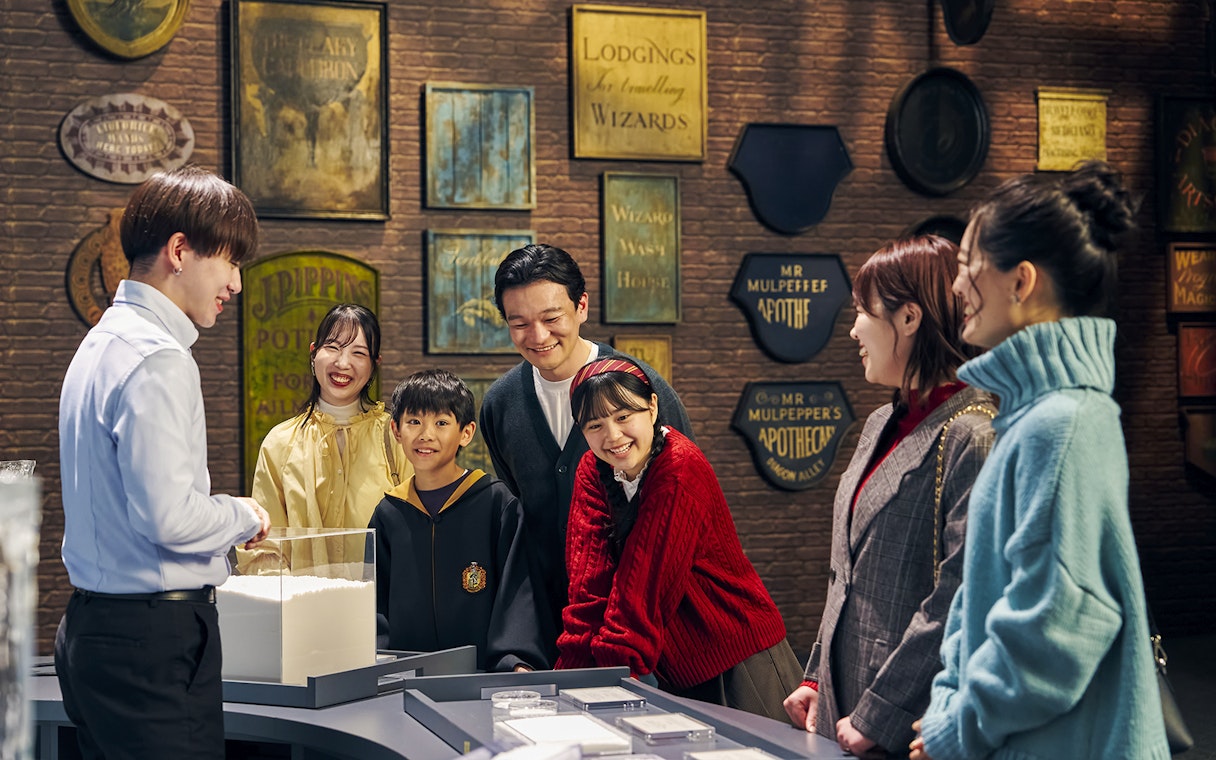Family enjoying interactive exhibit at The Making of Harry Potter Studio Tour, Tokyo.
