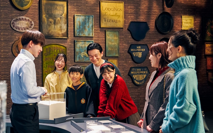 Family enjoying interactive exhibit at The Making of Harry Potter Studio Tour, Tokyo.