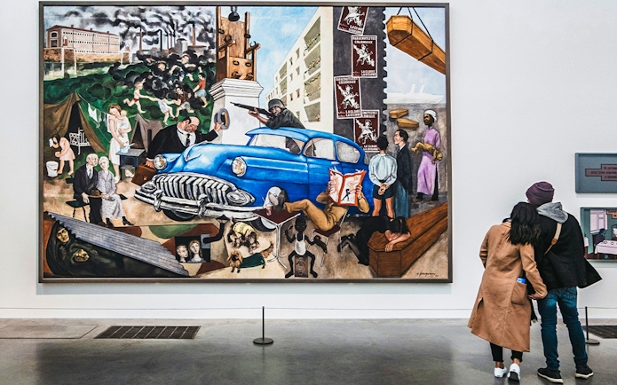 Visitors viewing a large, colorful painting at Tate Modern, London.