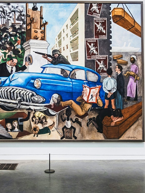 Visitors viewing a large, colorful painting at Tate Modern, London.