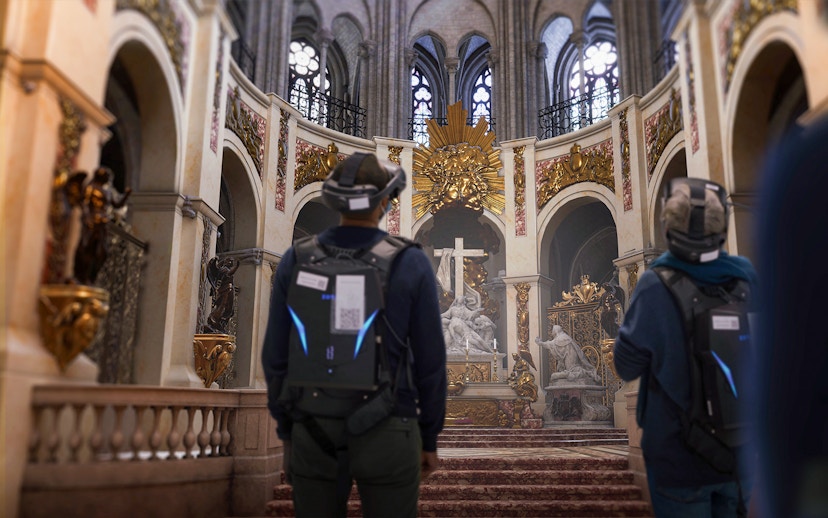 Visitors experiencing Notre-Dame Cathedral in virtual reality, Paris, highlighting historical architecture.